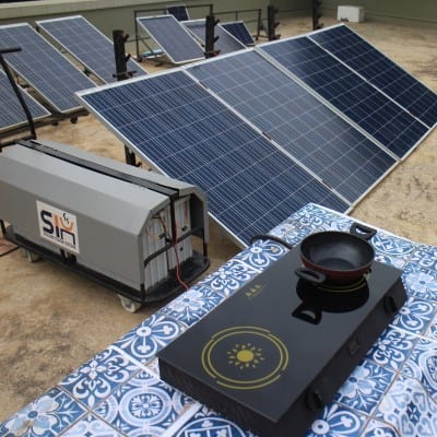 This solar kitchen comes with a pot and a solar-cooking device
